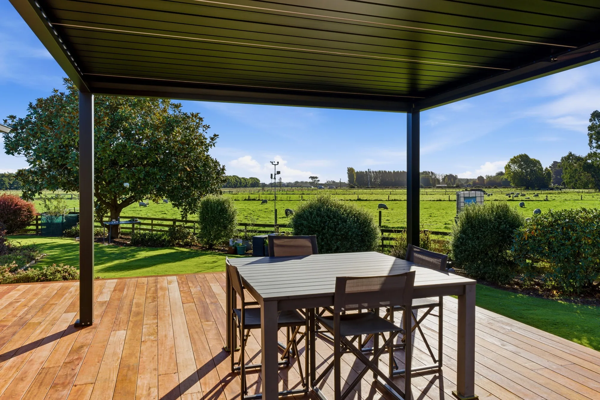 Louvre roof over timber deck with rural Canterbury pasture view - Christchurch outdoor room